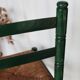 Vintage children's chair in green wood with a woven straw seat