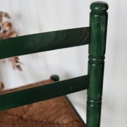 Vintage children's chair in green wood with a woven straw seat