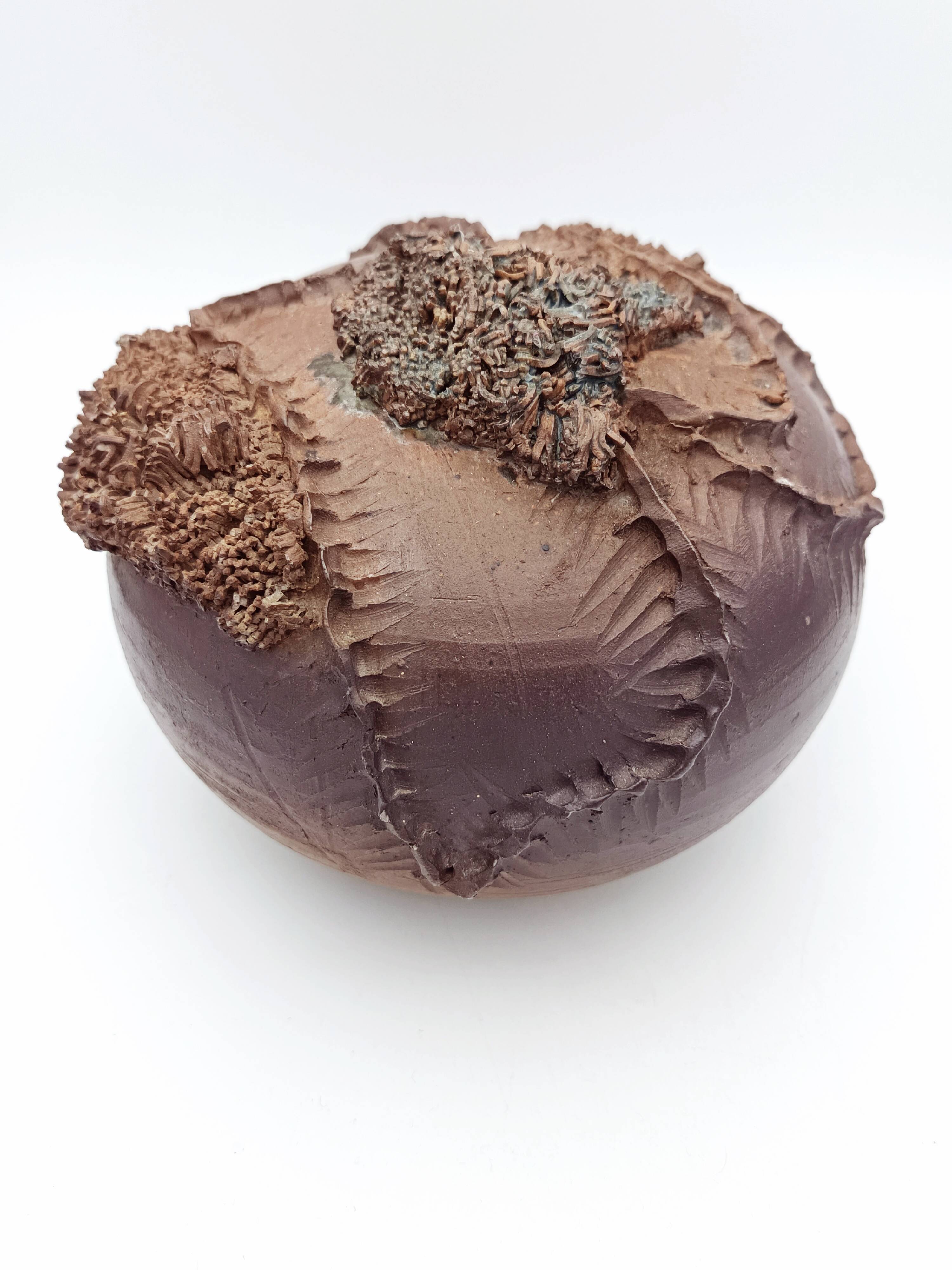 Ceramic vase with organic plant decoration