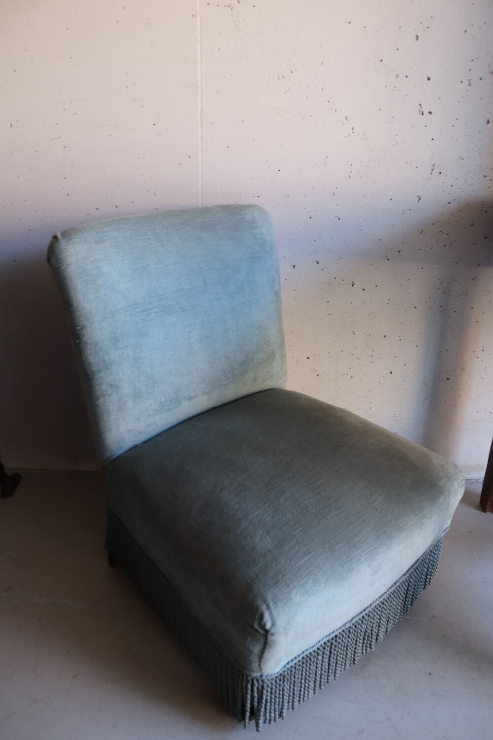 Vintage blue velvet fringed armchair.