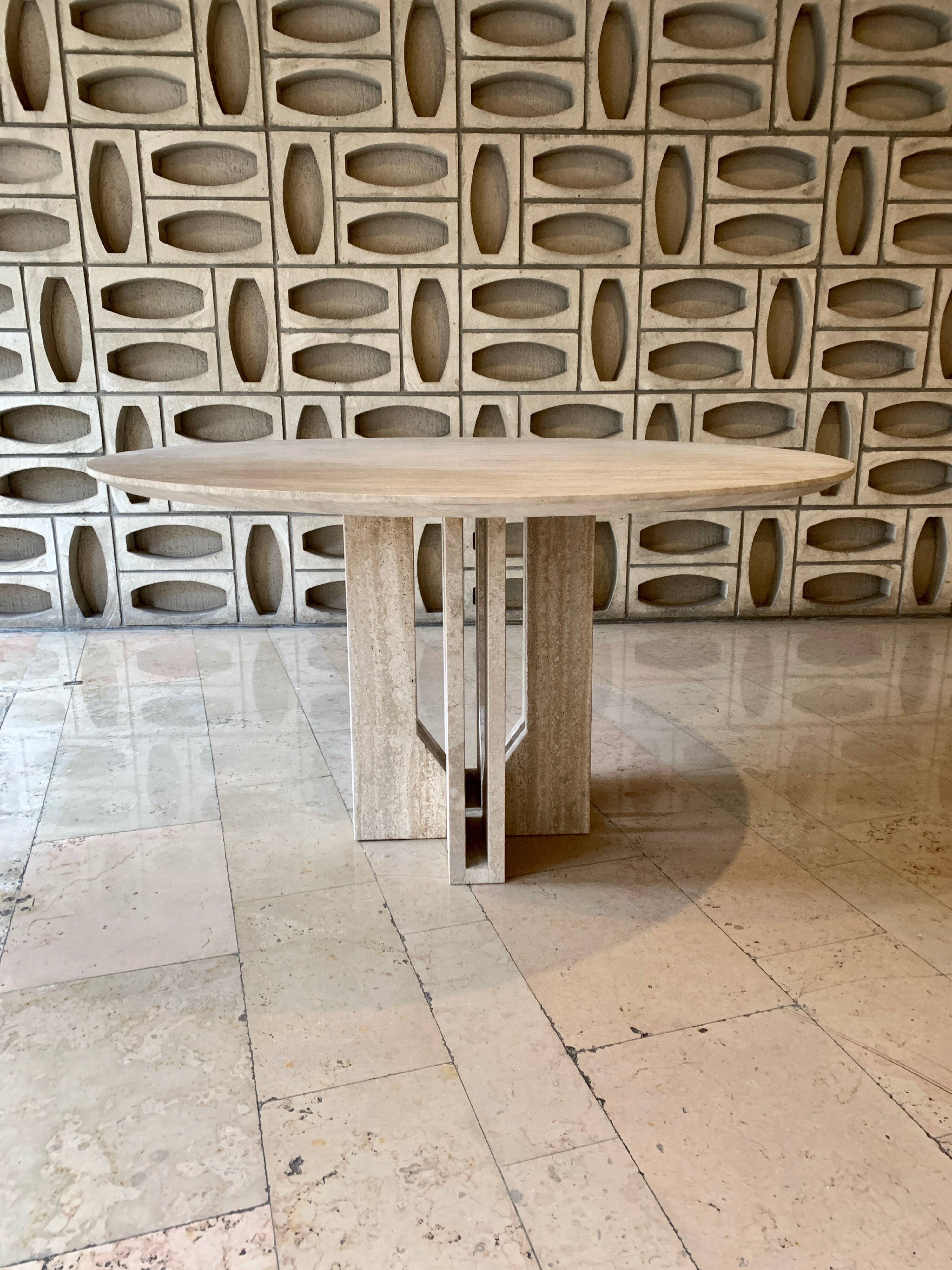 Round travertine dining table by Claude Berraldacci