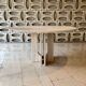 Round travertine dining table by Claude Berraldacci