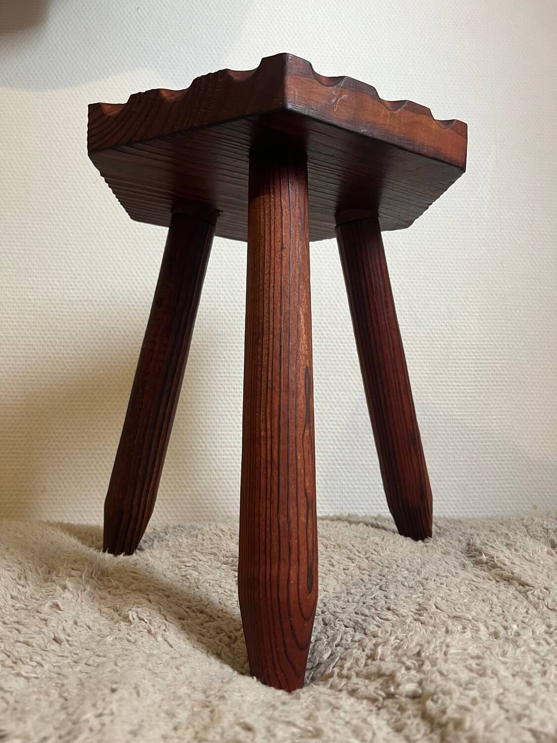 Wooden tripod stool in mountain chalet style