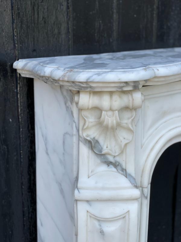 Louis XV style fireplace in white Carrara marble arabescato