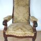 An antique armchair from the turn of the 19th and 20th centuries, carved wa