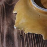Empty yellow ceramic pocket in the shape of a leaf