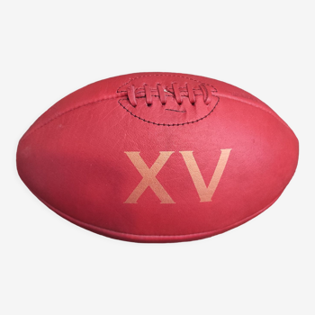 Vintage red leather rugby ball with the number XV