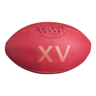 Vintage red leather rugby ball with the number XV