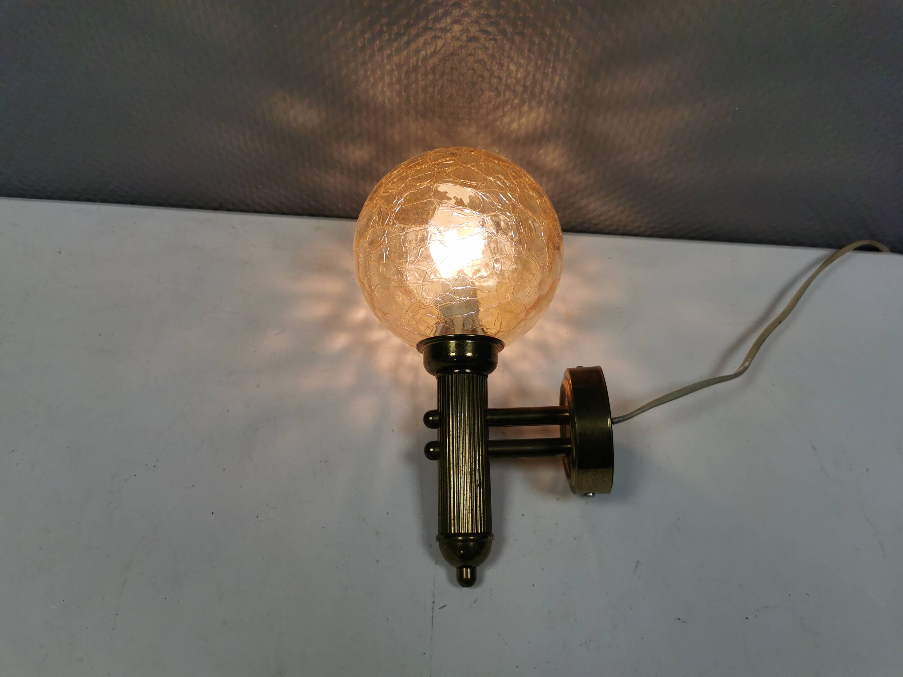 Older wall lamp in metal, brass and “cracked” glass.