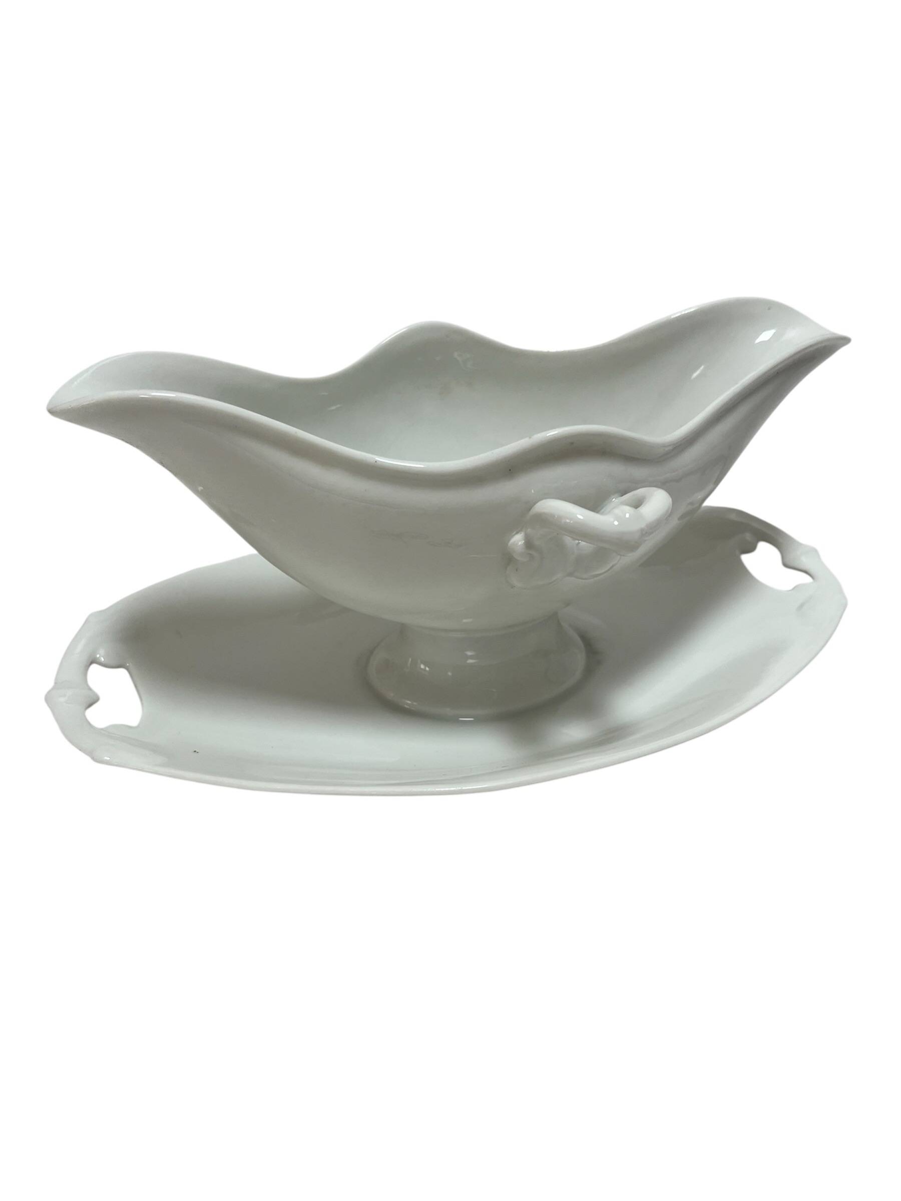White porcelain sauce boat on tray