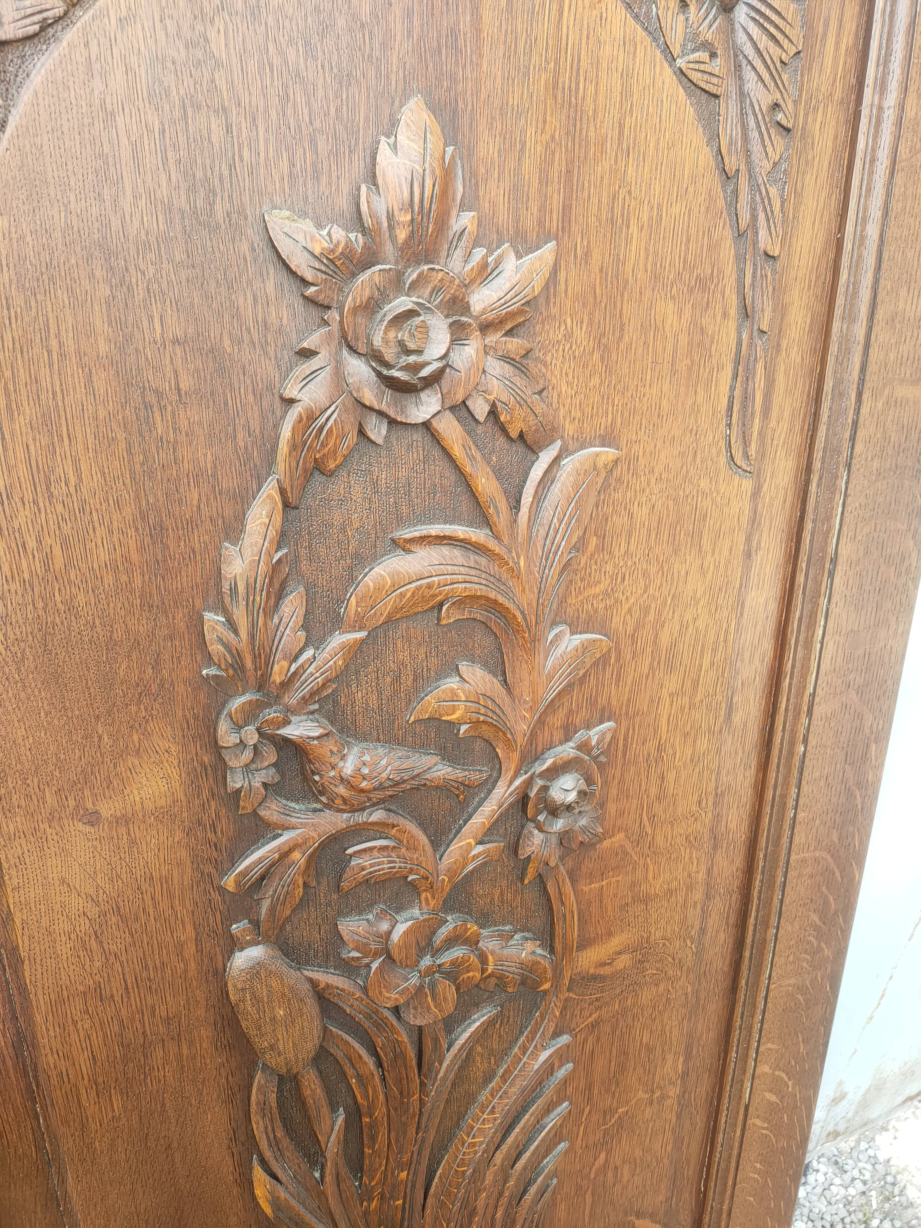 pair of antique solid oak cabinet doors with bird decor