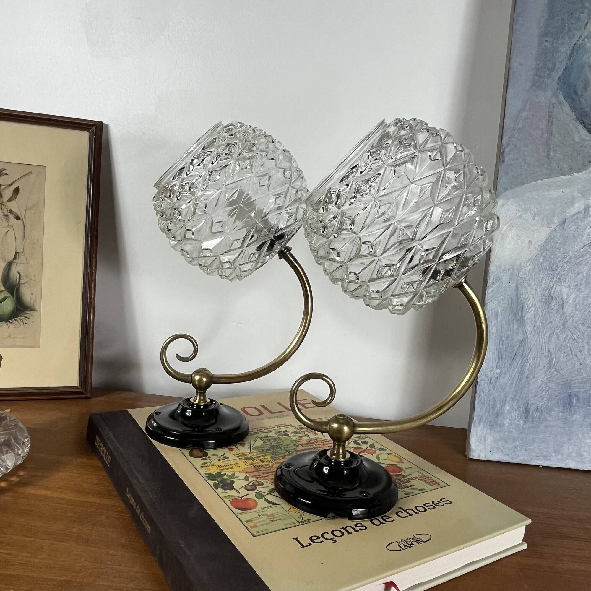 Pair of antique wall sconces with swan necks and glass globes.