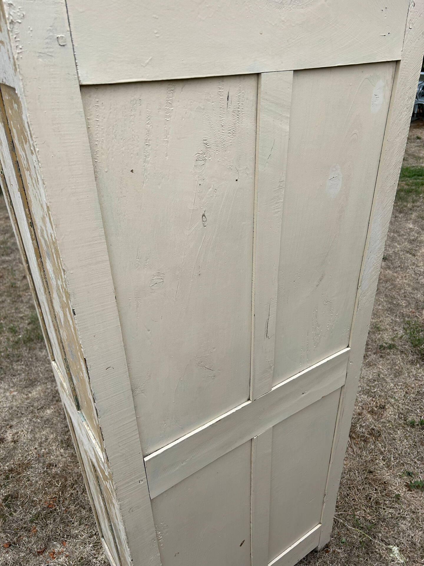 Small antique wardrobe with a faded white patina.