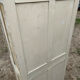 Small antique wardrobe with a faded white patina.
