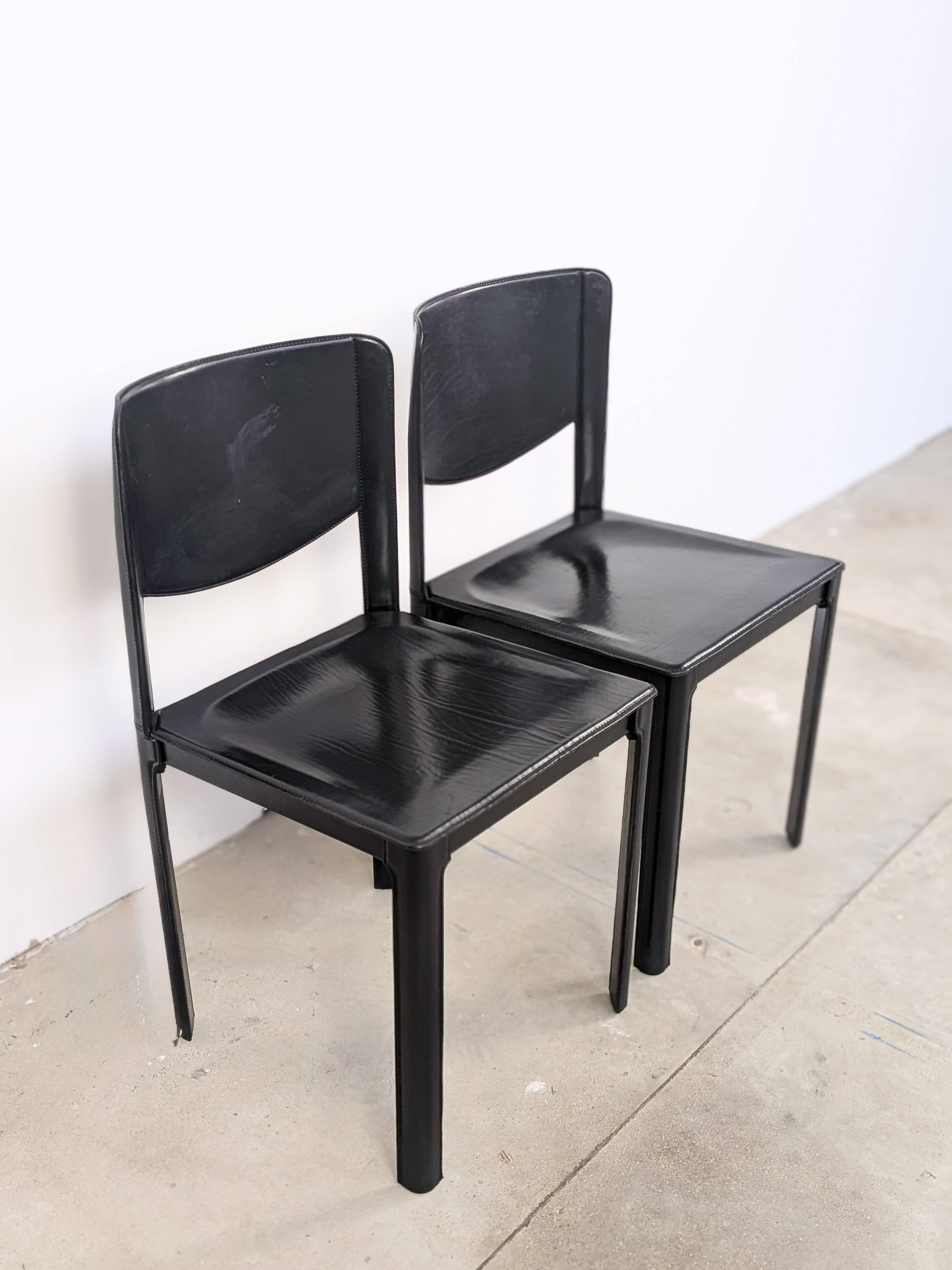 Pair of Matteo Grassi chairs in black saddle leather, 1980s.