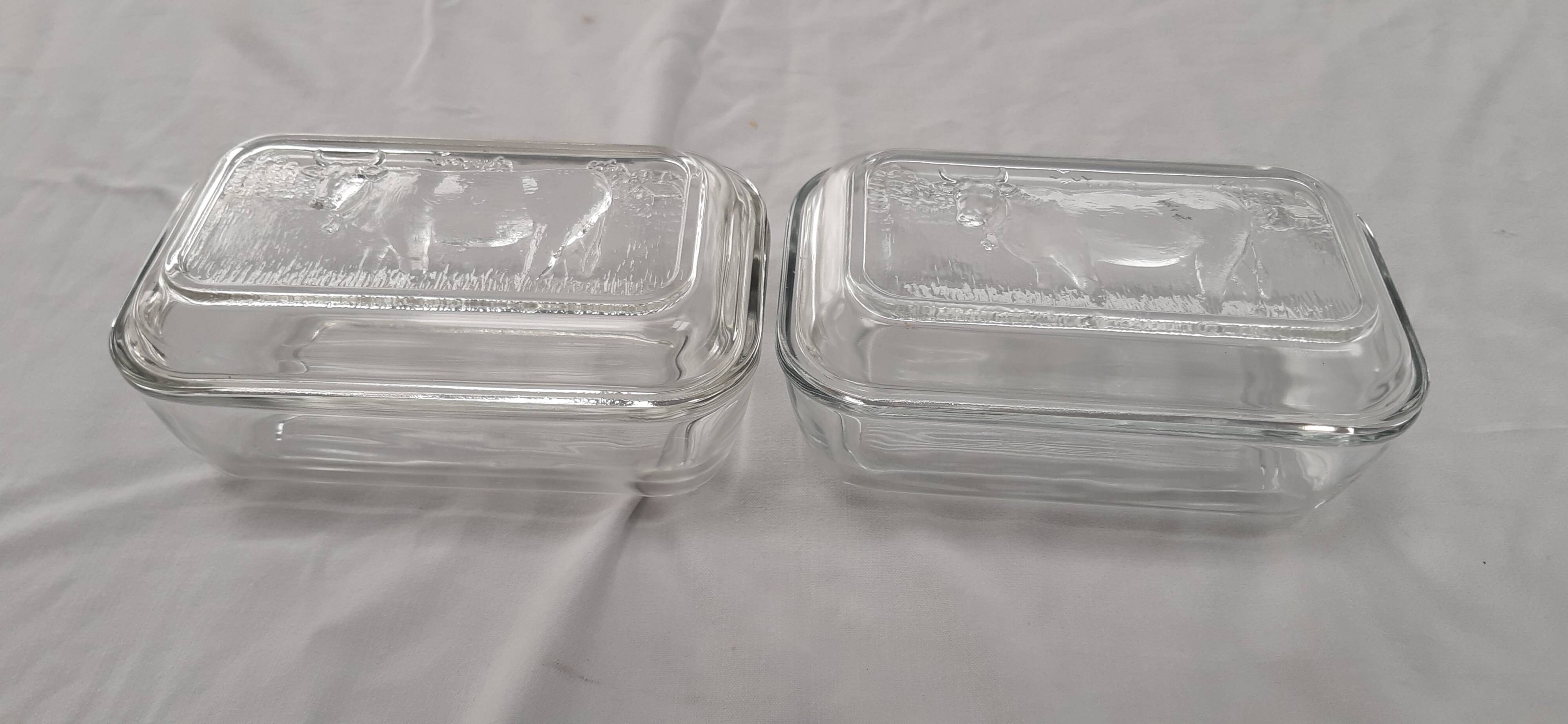 Two Arcoroc glass dairy cow butter dishes