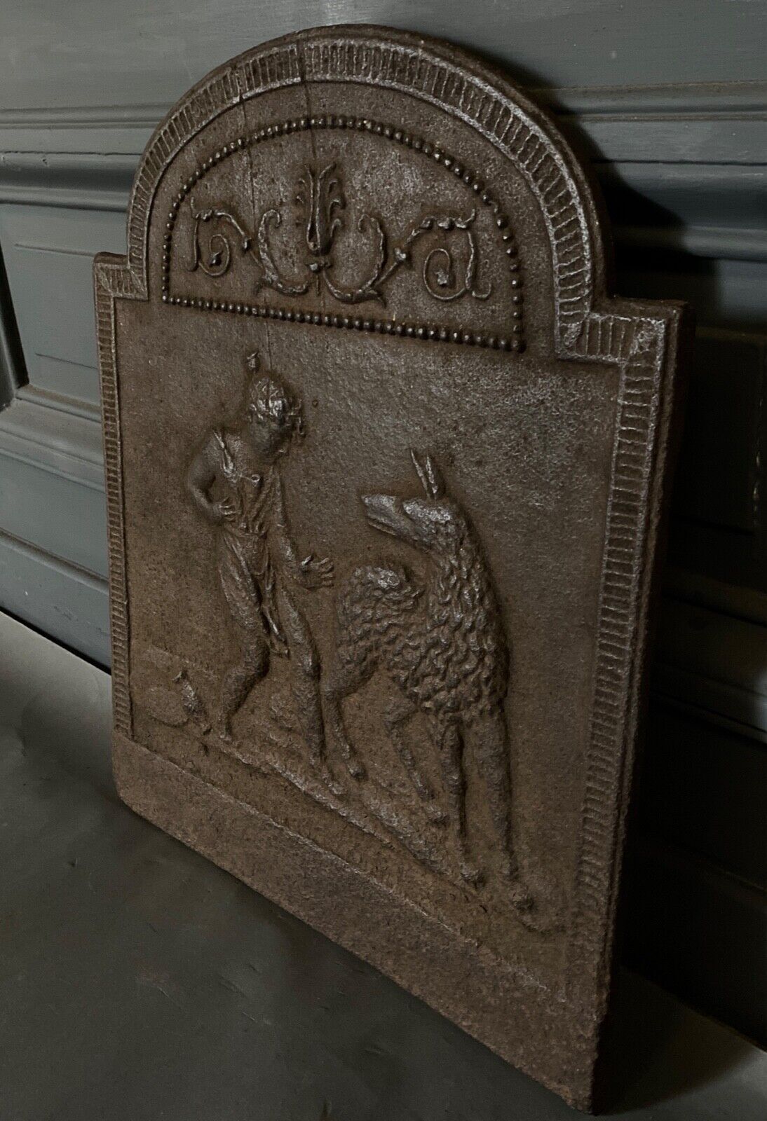 EIGHTEENTH CENTURY CAST IRON FIREPLACE PLATE REPRESENTING A WOMAN AND A WOLF