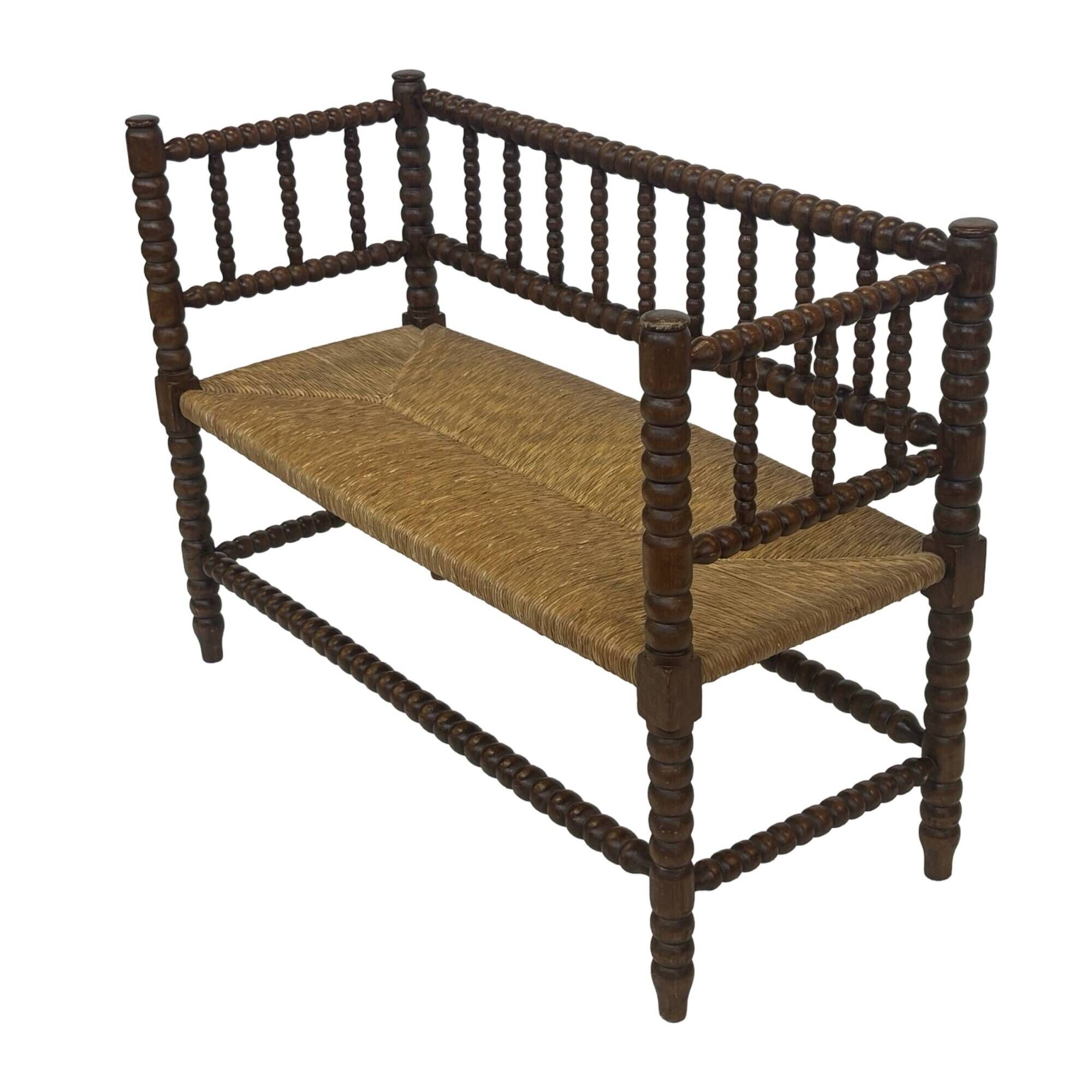 Vintage 'bobbin' bench with a rush seat, 1920s design with armrests.