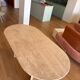 Oblong dining table in beige travertine.