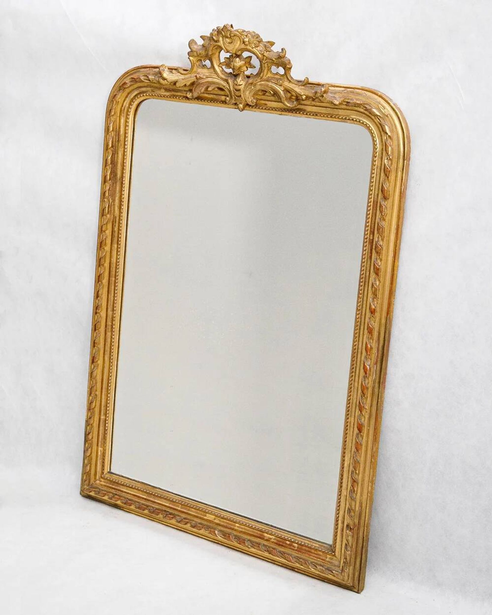Louis-Philippe mirror from the 19th century with a ribbon trompe-l'œil frame.