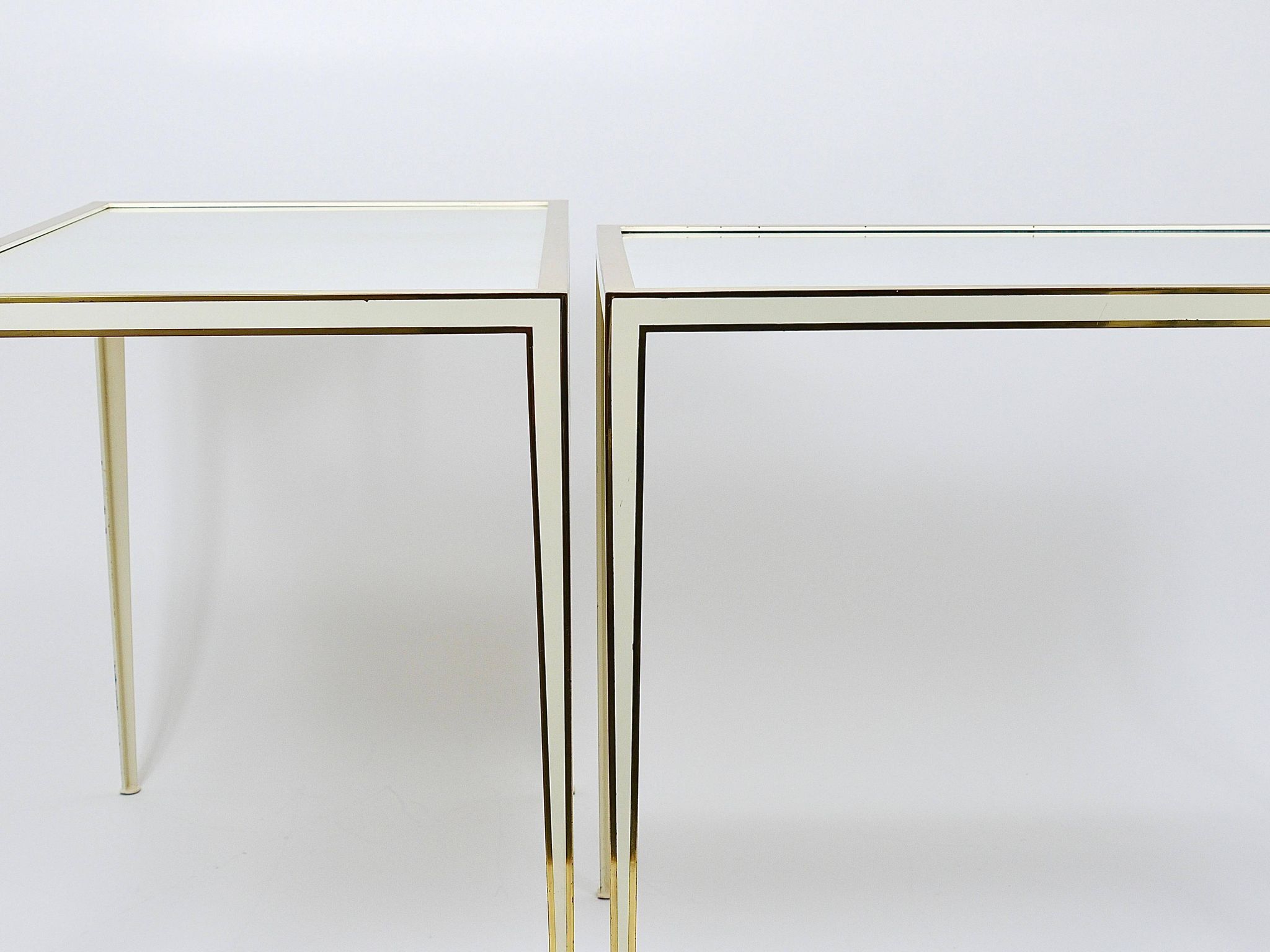 A pair of brass and white mirror tables from Vereinigte Werkstätten, Germany, 1970s.