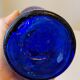 Vintage decanter bottle made of blue molded pressed glass