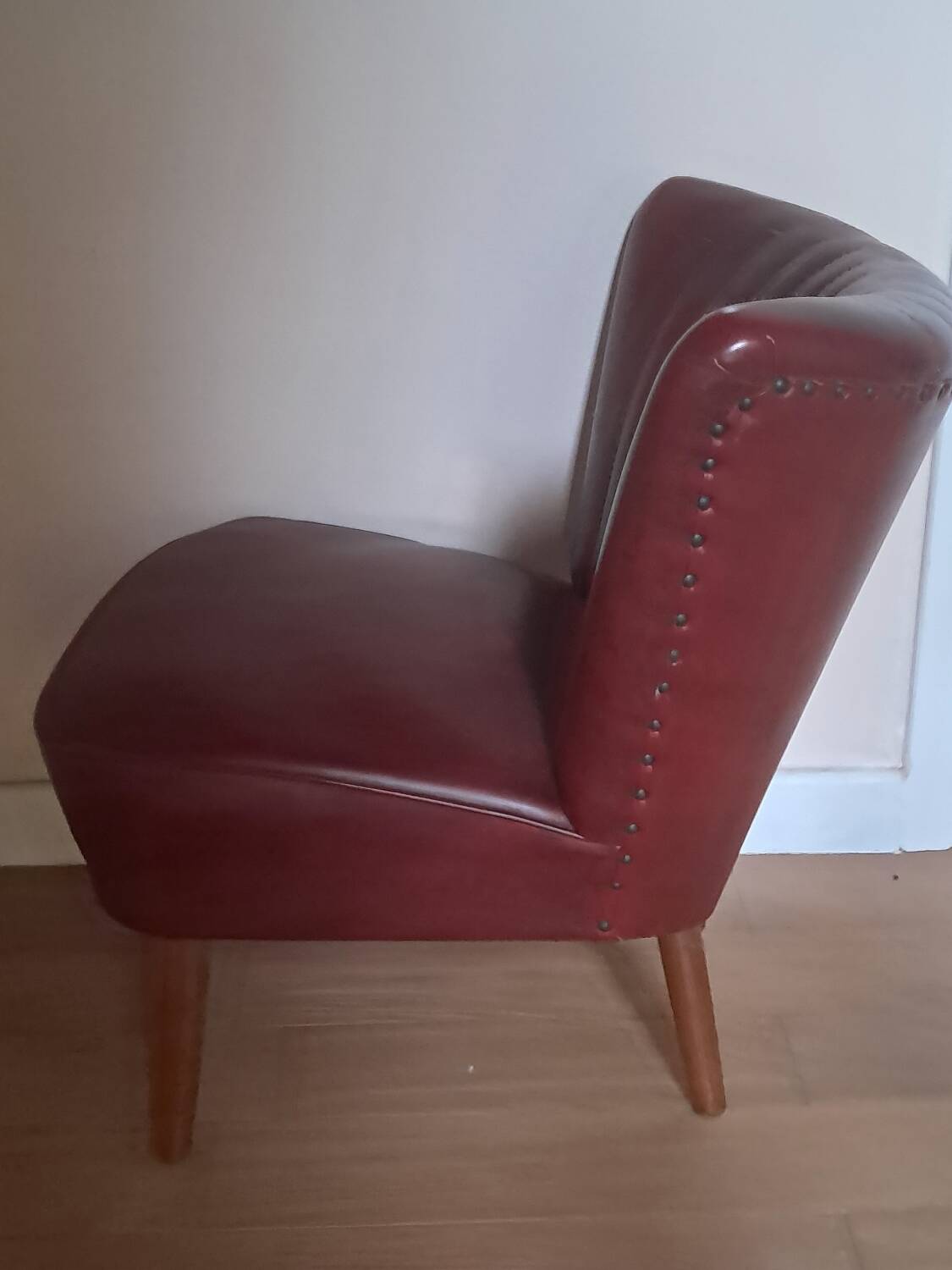 Burgundy leatherette cocktail chair, circa 1958