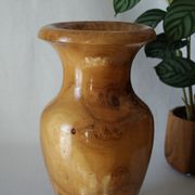 Artisanal turned olive wood vase with varnish.