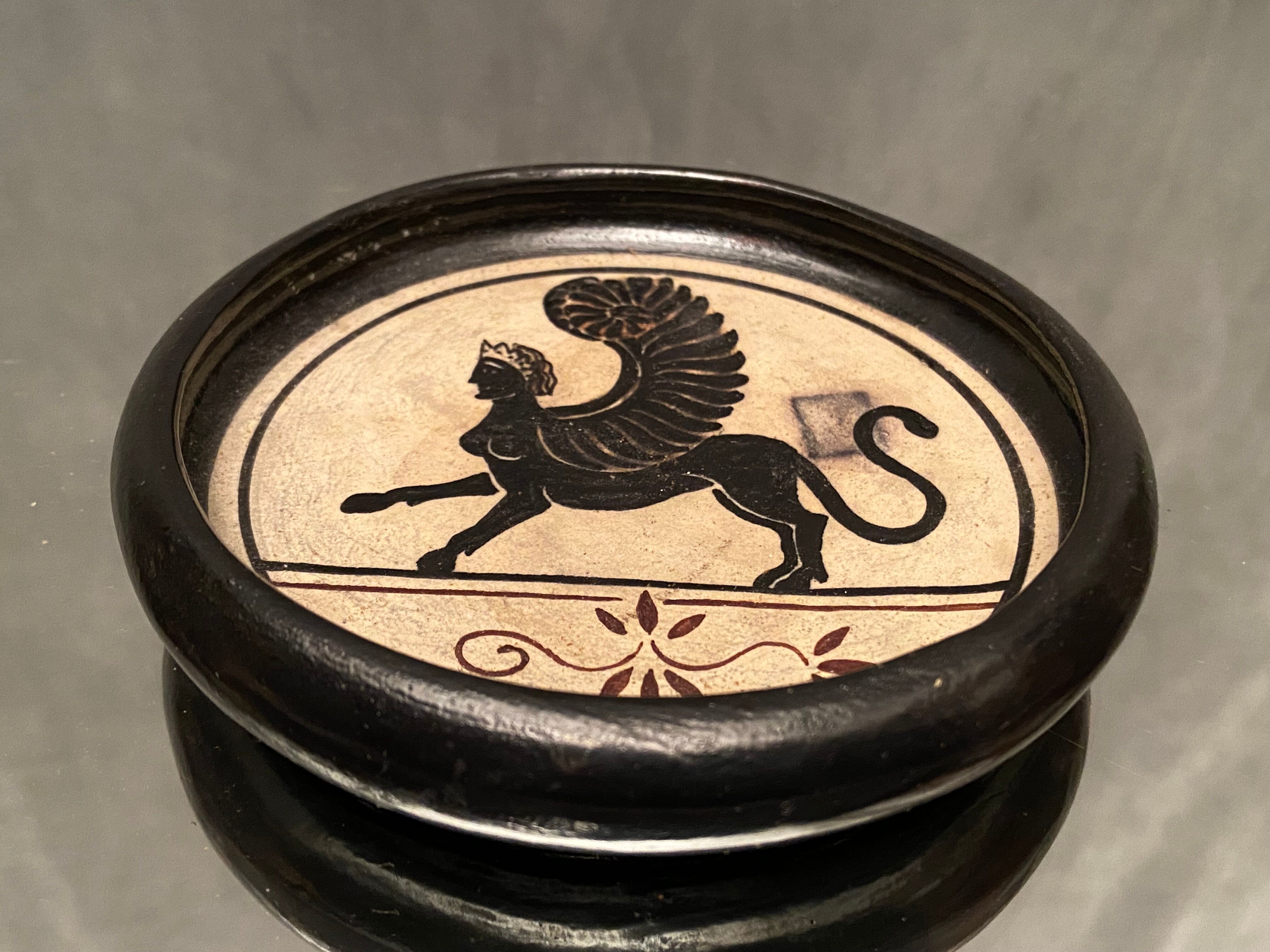 Cup decorated with winged sphinx in Ciboure sandstone signed Marie Fernandez