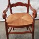 Old country armchair wood and natural straw