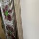 Large square ceramic mirror with floral decoration.