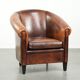 Sheepskin club armchair with deep warm colours and black piping