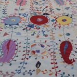 White suzani kilim rug with hand embroidered multi-colored patterns