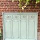 Cloakroom with sage green wall coats