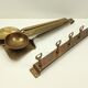 5 kitchen utensils and a brass wall mount