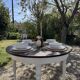 Restored solid wood round table with integrated extensions.