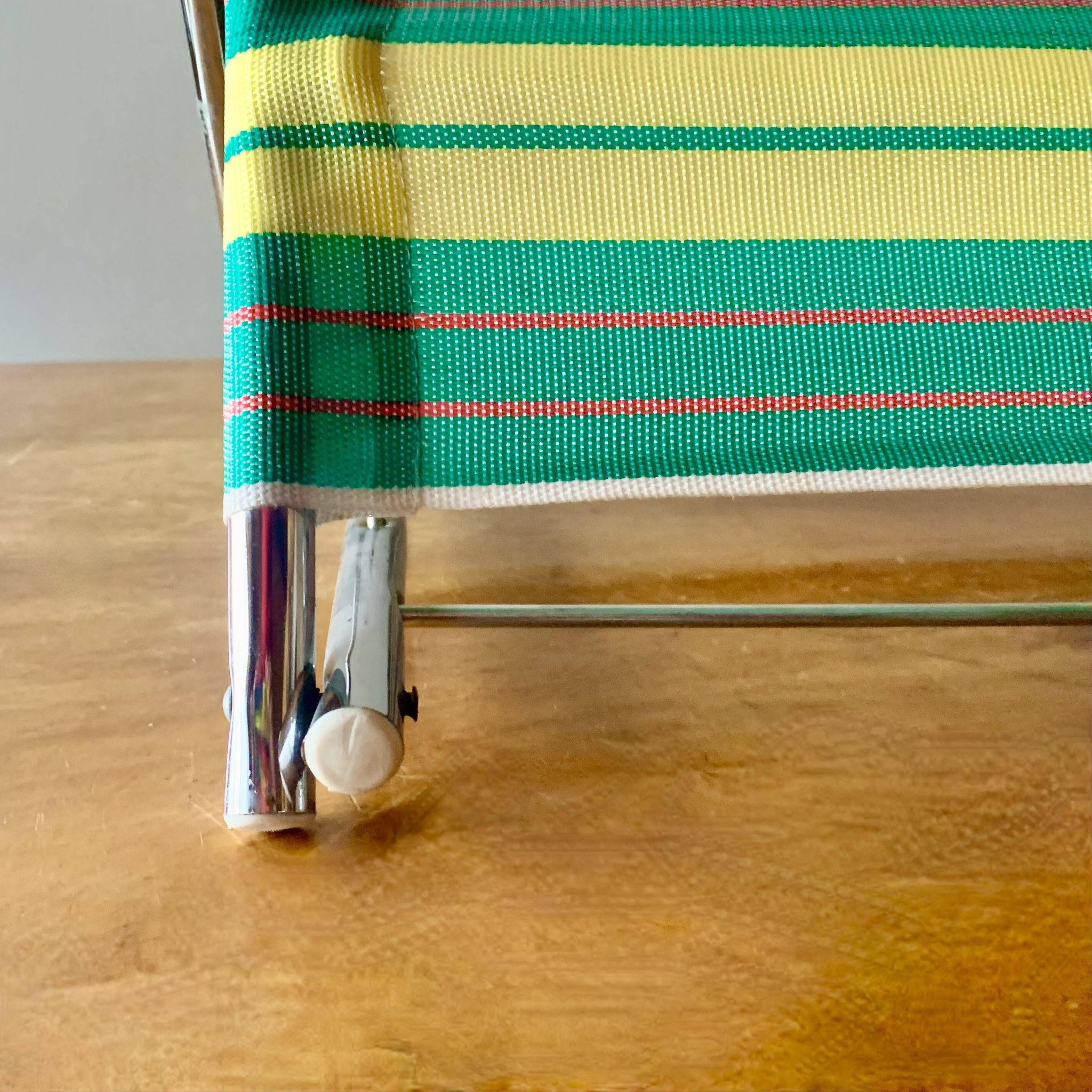 Vintage folding beach chair in chrome metal and woven plastic