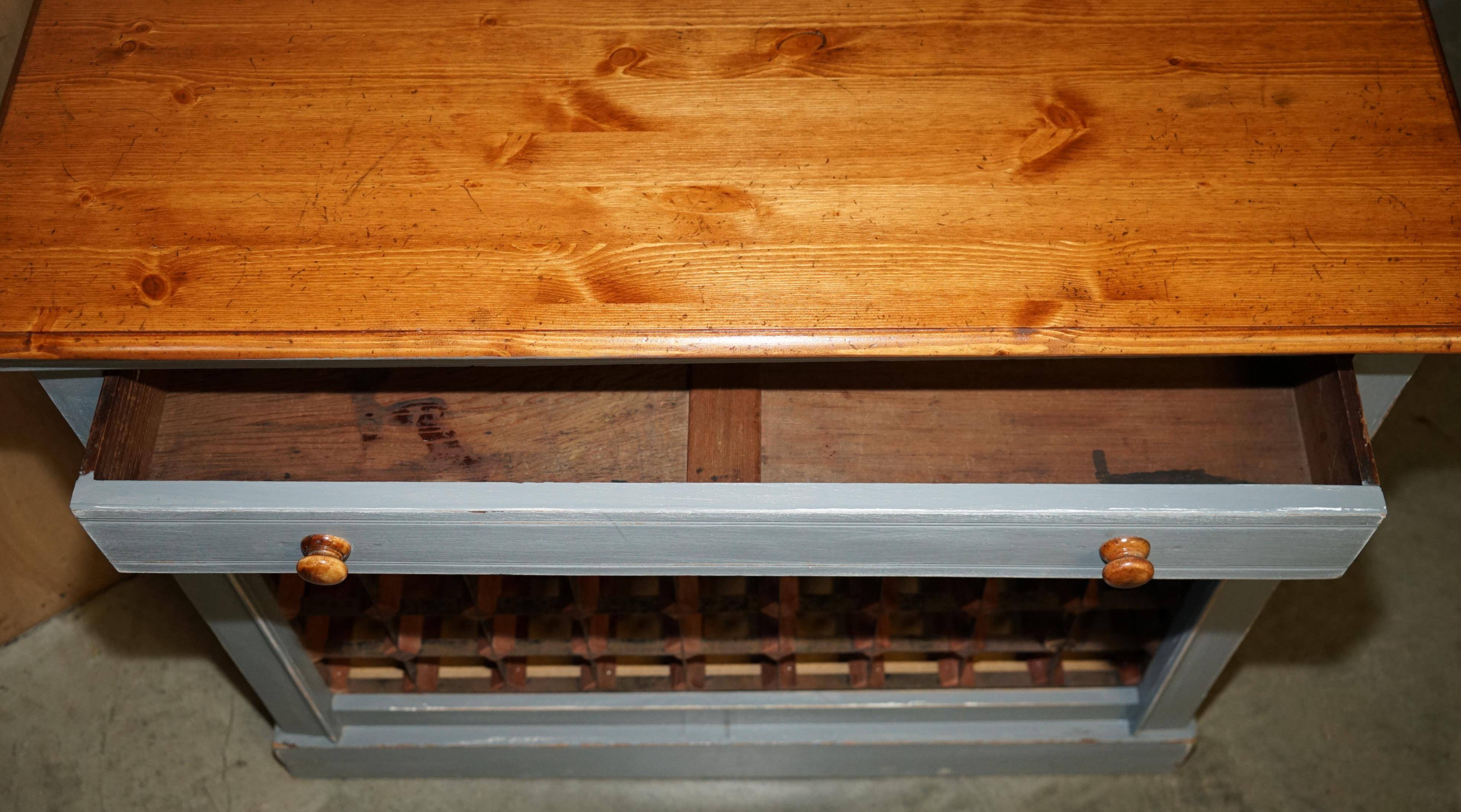 Vintage wooden furniture for 45 wine bottles with a drawer.