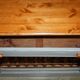 Vintage wooden furniture for 45 wine bottles with a drawer.