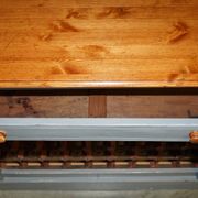 Vintage wooden furniture for 45 wine bottles with a drawer.