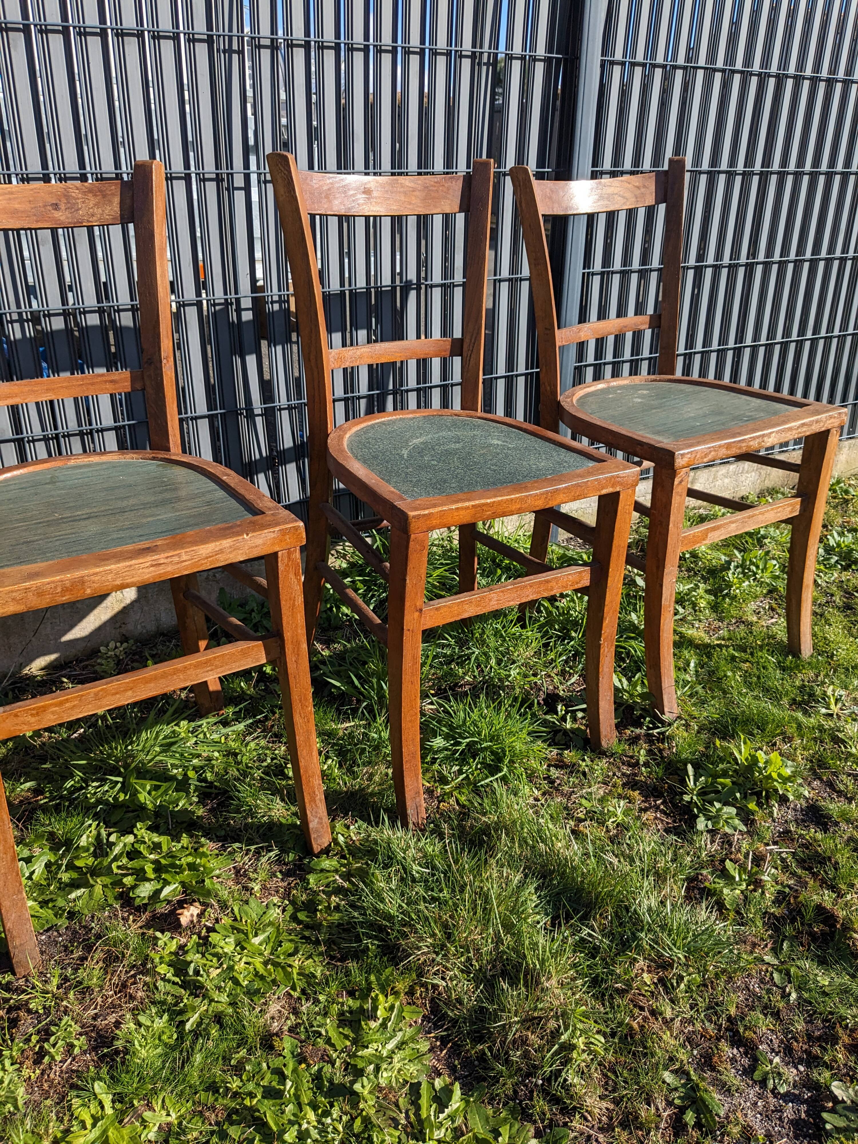 Set of four wooden bistro chairs, green seat, mid-20th century.