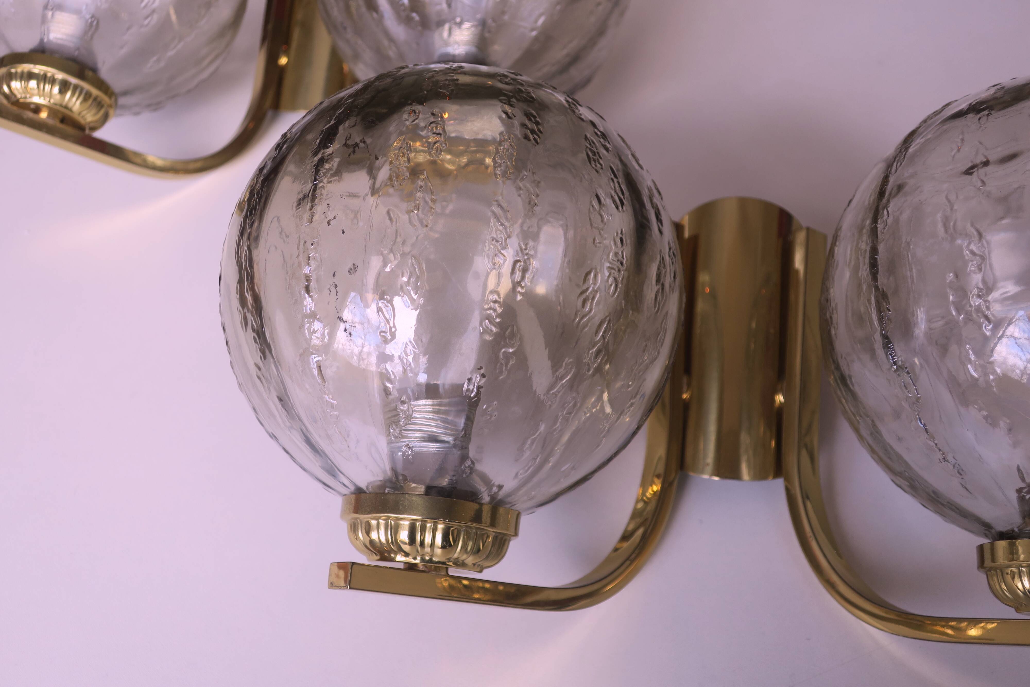 Mid century pair of brass and glass double wall lights, 1970s