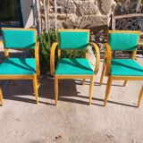 3 vintage bridge chairs with rounded armrests.