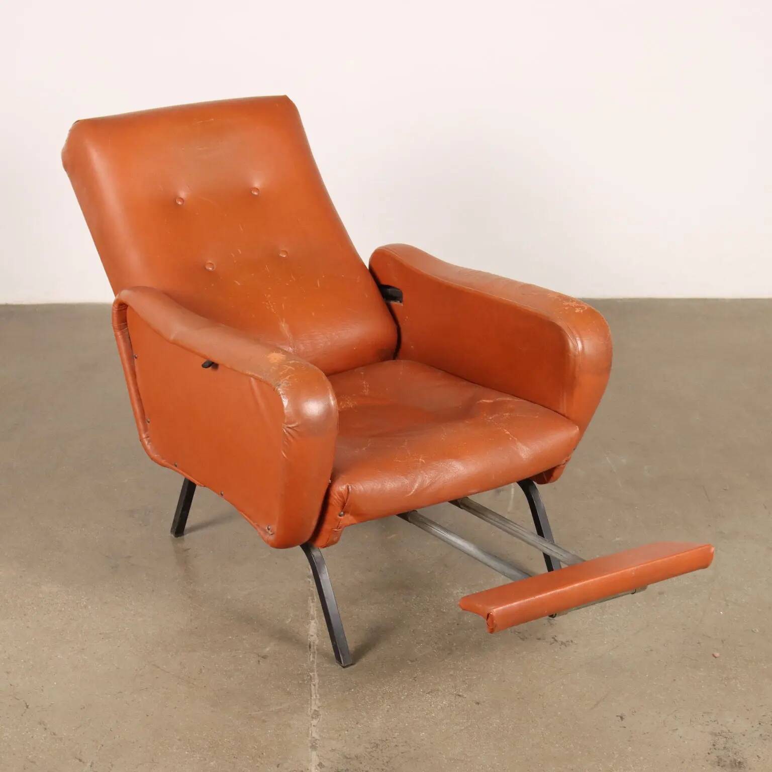 Vintage armchair from the 1970s in foam, faux leather, and metal.