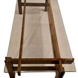 Glass coffee table with a wooden frame.