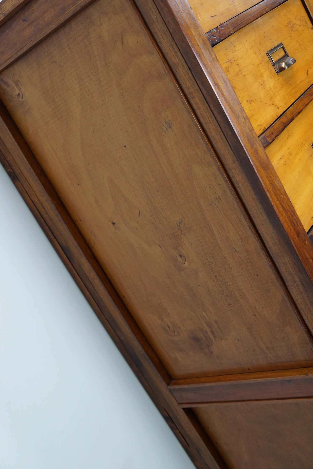 School cabinet bank of vintage Dutch drawers in mid-twentieth century pine