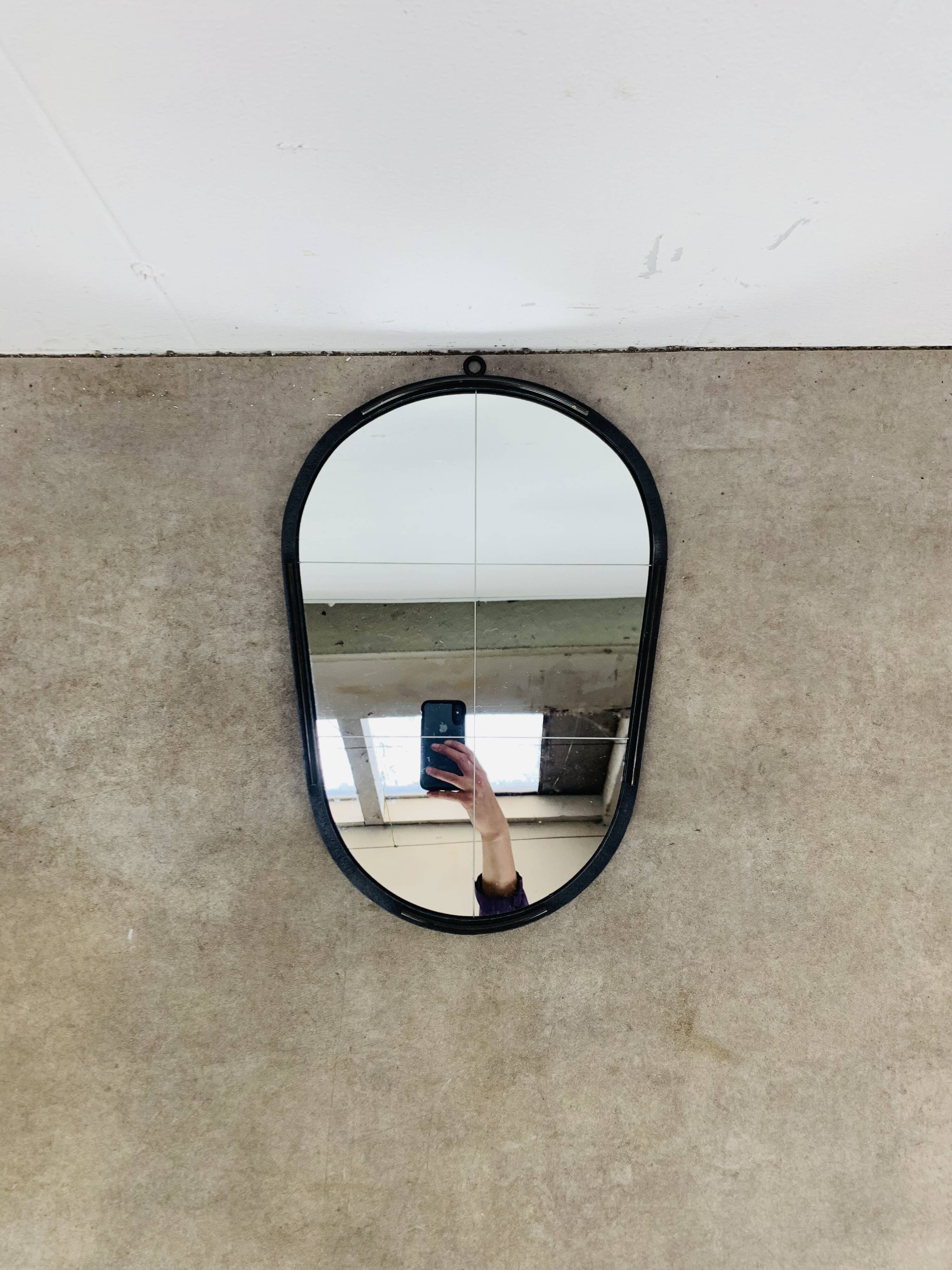 Oval mirror from the 1950s, wrought iron and brass.