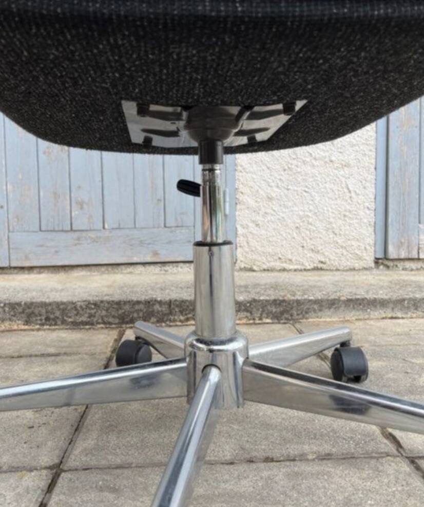 Black mottled fabric and chrome swivel armchair, 1