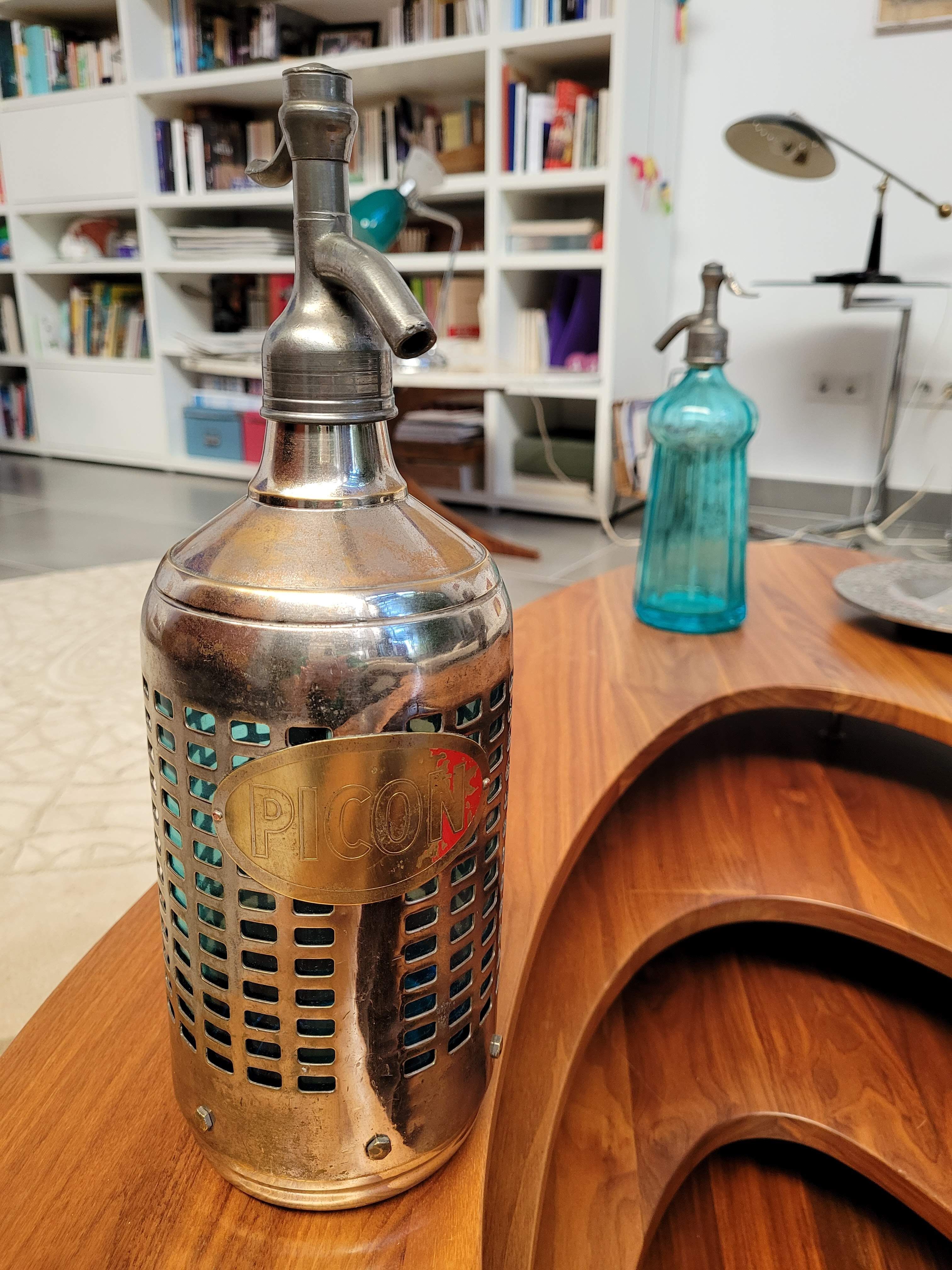 Seltzer water siphon in its protective grid