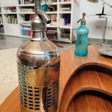 Seltzer water siphon in its protective grid